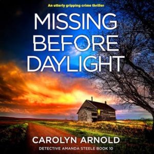 Missing Before Daylight by Carolyn Arnold, an old cabin with a light on in the window, overgrown grass on the side of a dirt road, under a fiery early morning sky.