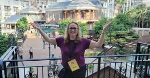 Carolyn Arnold with hands raised celebrating 10 years as a full time author at the Gaylord Opryland Resort Nashville, Tennessee, during Bouchercon.